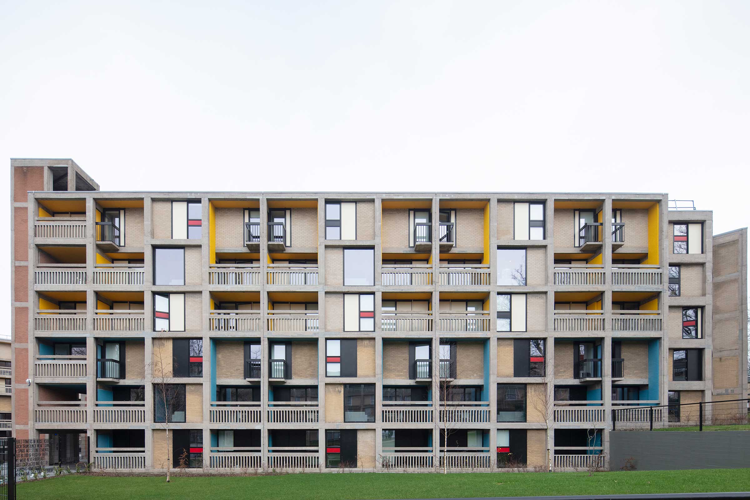 A brutalist appartment block that has been renovated with aluminium windows
